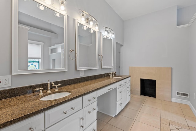 884 Neil Ave, Columbus, OH 43215 - full bathroom featuring double vanity, tile patterned floors, and a fireplace