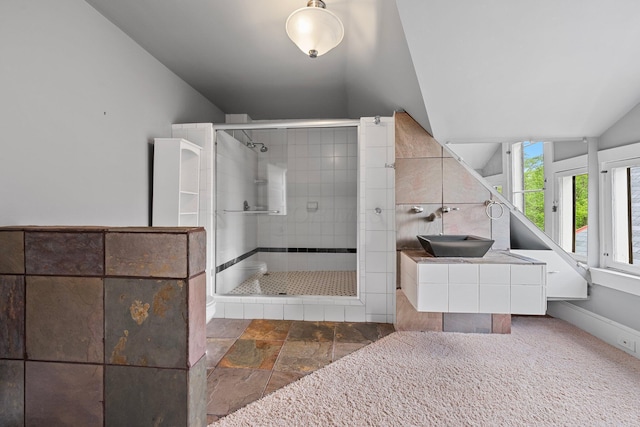 884 Neil Ave, Columbus, OH 43215 - full bathroom with lofted ceiling, a stall shower, vanity, and stone finish flooring
