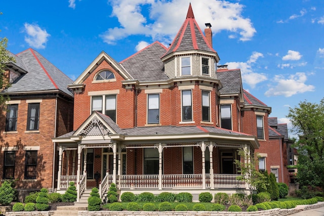 884 Neil Ave, Columbus, OH 43215 - victorian home featuring covered porch, a chimney, brick siding, and a high end roof