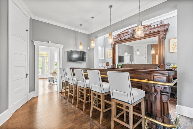 884 Neil Ave, Columbus, OH 43215 - bar with wood finished floors, crown molding, and decorative light fixtures