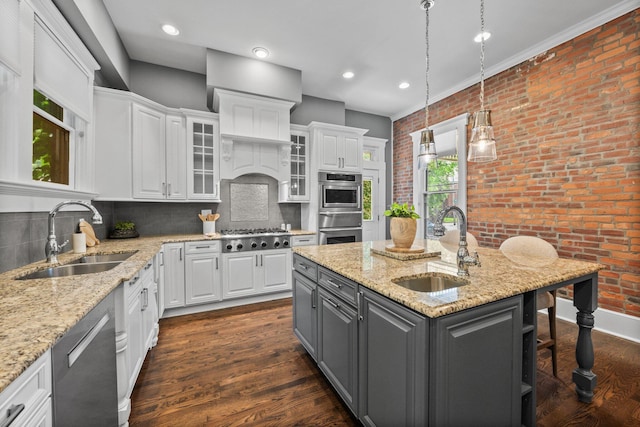 884 Neil Ave, Columbus, OH 43215 - kitchen with gray cabinets, white cabinets, appliances with stainless steel finishes, brick wall, and a center island with sink