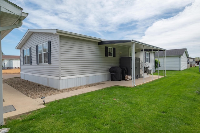 view of home's exterior featuring a lawn and a patio area