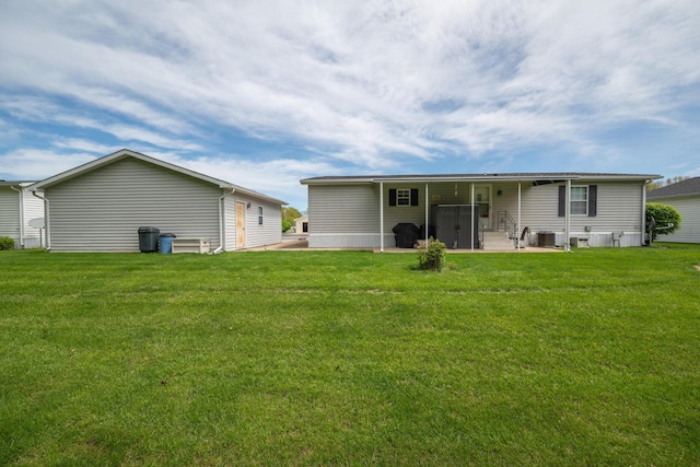 back of property with a lawn, cooling unit, and a patio area