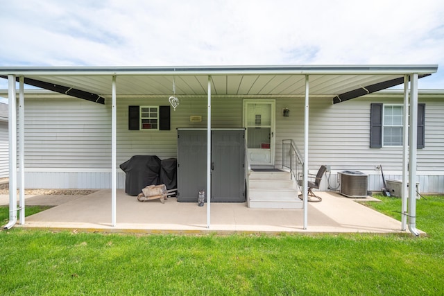 rear view of house featuring central air condition unit and a yard