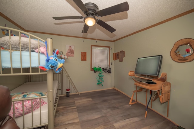 bedroom featuring a textured ceiling, a ceiling fan, baseboards, wood finished floors, and ornamental molding