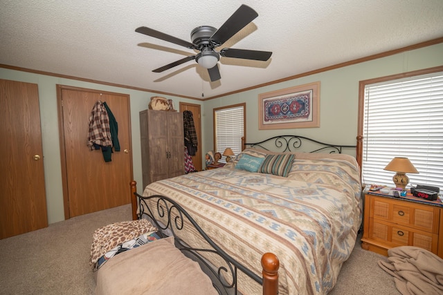 carpeted bedroom featuring a ceiling fan, a textured ceiling, and ornamental molding
