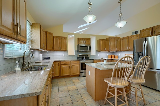 4656 Meadowgrove Dr NW, Carroll, OH 43112 - kitchen featuring stainless steel appliances, lofted ceiling, decorative backsplash, a center island, and a sink