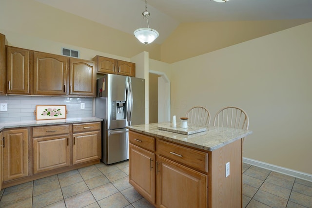 4656 Meadowgrove Dr NW, Carroll, OH 43112 - kitchen featuring stainless steel refrigerator with ice dispenser, lofted ceiling, light tile patterned floors, decorative backsplash, and a center island