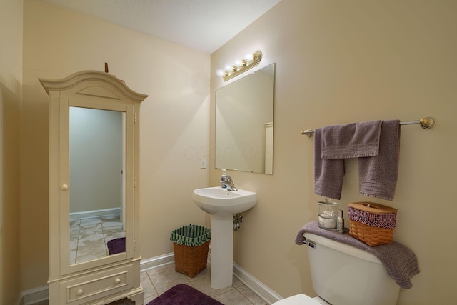 4656 Meadowgrove Dr NW, Carroll, OH 43112 - half bathroom with toilet, baseboards, tile patterned flooring, and a sink