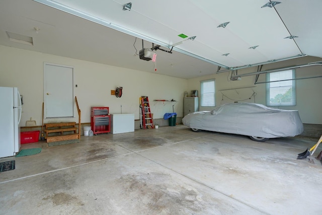 4656 Meadowgrove Dr NW, Carroll, OH 43112 - garage featuring freestanding refrigerator and a garage door opener