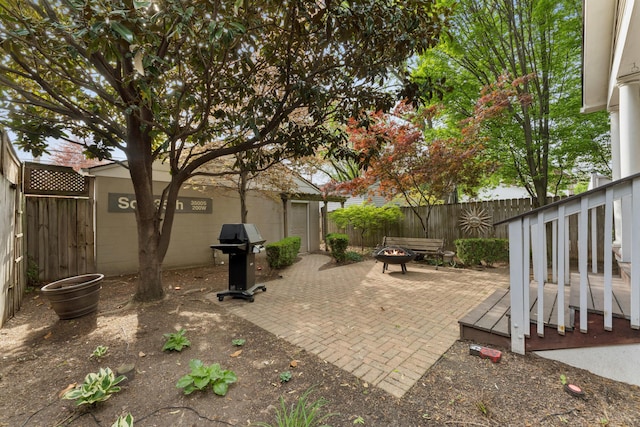view of patio / terrace with a fenced backyard, a fire pit, and area for grilling