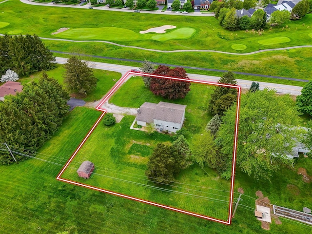 birds eye view of property with golf course view and a residential view