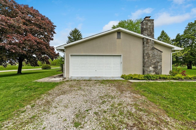 view of side of home featuring a chimney, stucco siding, a garage, and a lawn