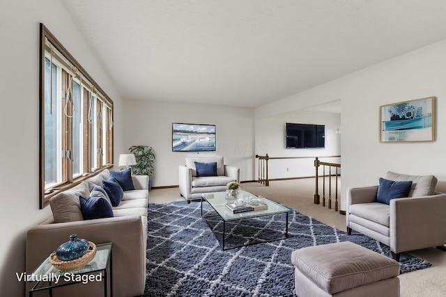carpeted living room featuring baseboards