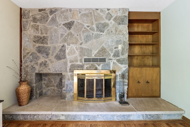 interior details with a fireplace, visible vents, and built in features