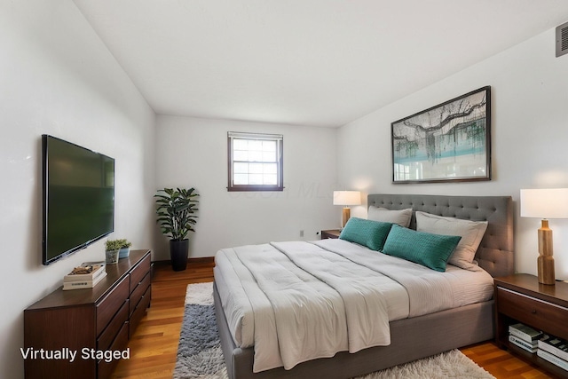 bedroom featuring visible vents and light wood-style floors
