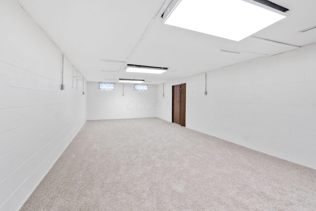 basement featuring carpet and concrete block wall