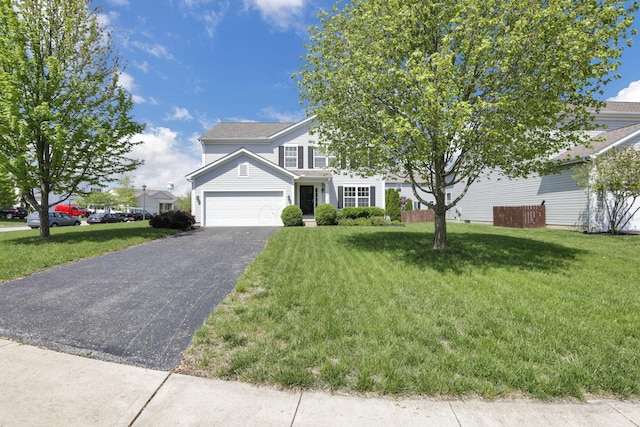 view of front of property with a garage, driveway, and a front lawn