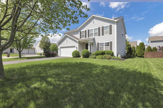traditional-style home with an attached garage, a front lawn, fence, and driveway