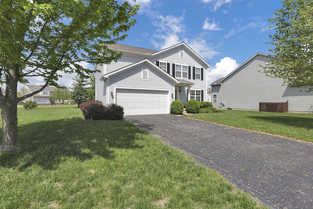 traditional-style house with an attached garage, driveway, and a front lawn