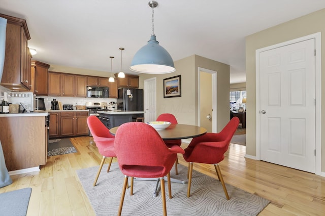 dining space with light wood-style flooring