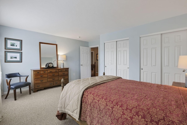 carpeted bedroom with two closets