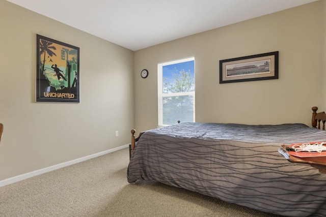 bedroom with baseboards and carpet