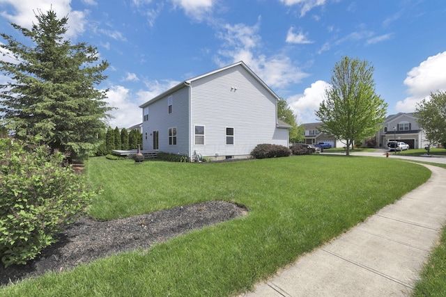 view of side of home featuring a yard