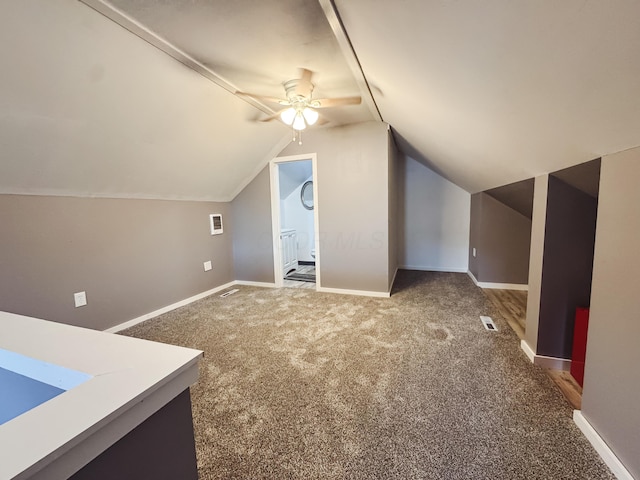 bonus room featuring ceiling fan, a sink, carpet, baseboards, and lofted ceiling