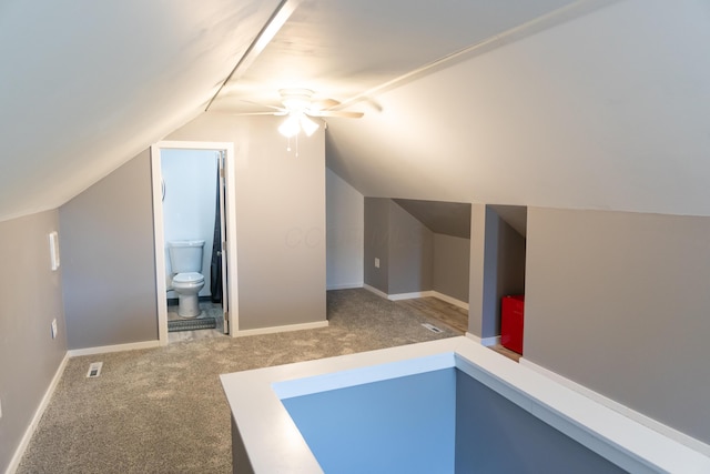 bonus room featuring visible vents, ceiling fan, vaulted ceiling, and carpet