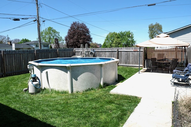 view of swimming pool with a gazebo, a fenced backyard, a yard, and a fenced in pool