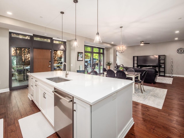 kitchen featuring white cabinets, a sink, dishwasher, a kitchen island with sink, and dark wood-style floors