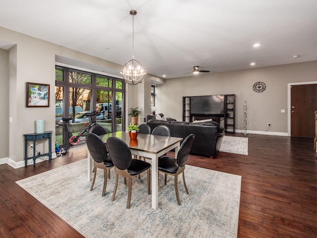 dining area with recessed lighting, baseboards, ceiling fan with notable chandelier, and dark wood-style flooring