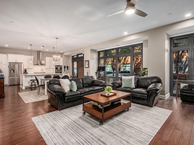 living area with dark wood-style flooring, a ceiling fan, and recessed lighting