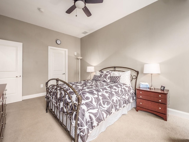 carpeted bedroom with a ceiling fan, baseboards, and visible vents