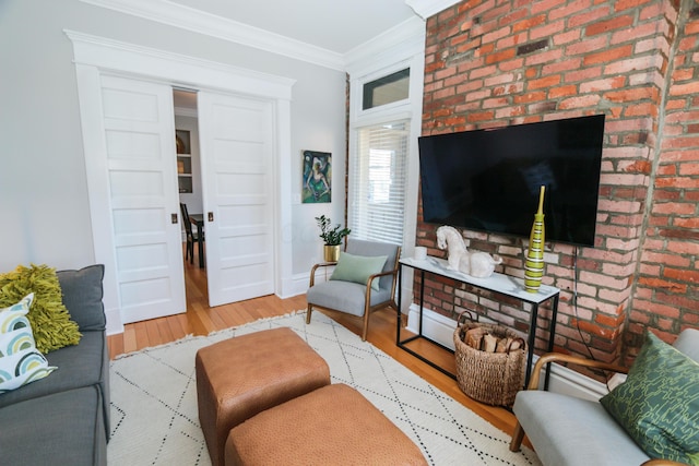 200 Thurman Ave, Columbus, OH 43206 - living room with crown molding, baseboards, wood finished floors, and brick wall