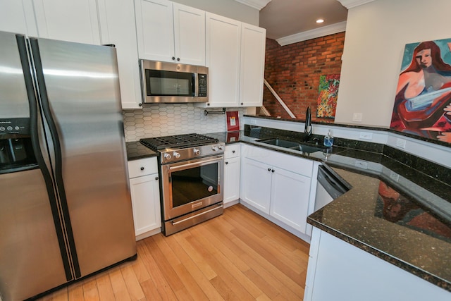 200 Thurman Ave, Columbus, OH 43206 - kitchen featuring crown molding, white cabinets, appliances with stainless steel finishes, a sink, and light wood-style floors