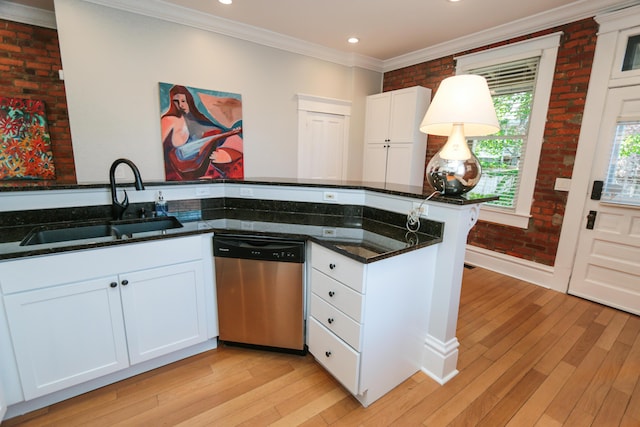 200 Thurman Ave, Columbus, OH 43206 - kitchen with stainless steel dishwasher, a sink, light wood-style floors, and crown molding