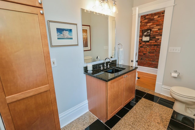 200 Thurman Ave, Columbus, OH 43206 - bathroom with baseboards, tile patterned flooring, toilet, and vanity