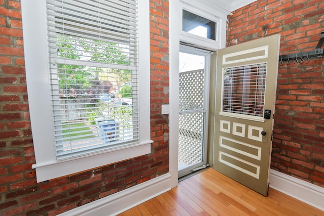 200 Thurman Ave, Columbus, OH 43206 - foyer featuring a healthy amount of sunlight, baseboards, light wood-type flooring, and brick wall
