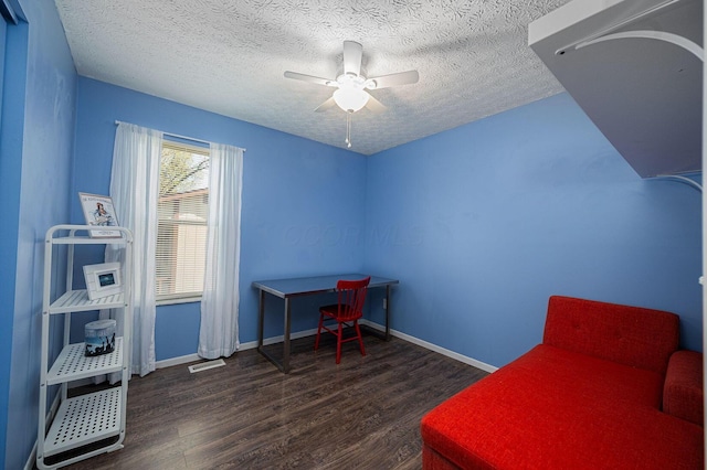 bedroom featuring a textured ceiling, baseboards, wood finished floors, and visible vents