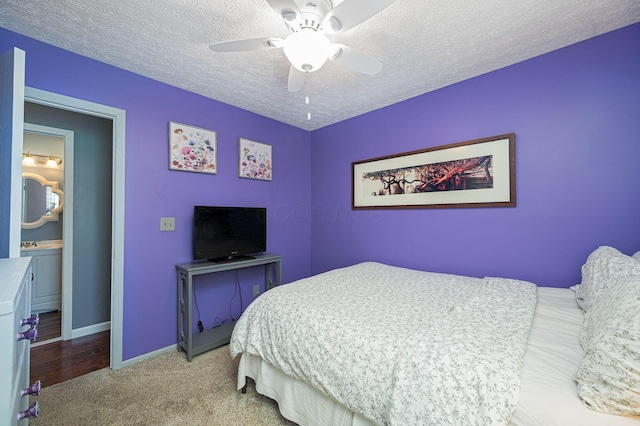 carpeted bedroom with baseboards, a ceiling fan, and a textured ceiling