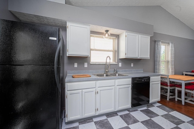 kitchen featuring a sink, black appliances, white cabinetry, and lofted ceiling
