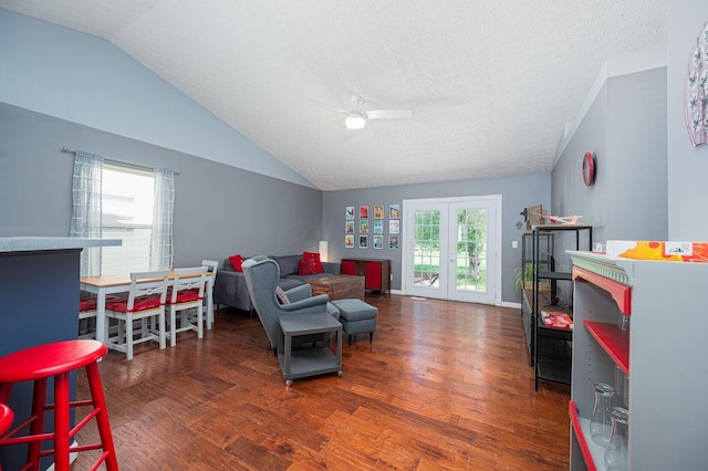 living area featuring a ceiling fan, french doors, wood finished floors, and lofted ceiling
