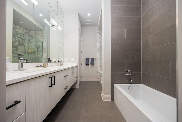 bathroom featuring visible vents, double vanity, a washtub, walk in shower, and a sink