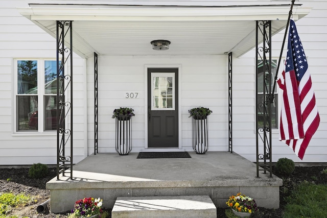view of exterior entry with a porch