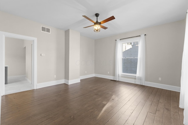 empty room with baseboards, ceiling fan, hardwood / wood-style floors, and visible vents