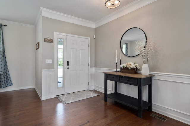 entryway with wainscoting, visible vents, ornamental molding, and wood finished floors