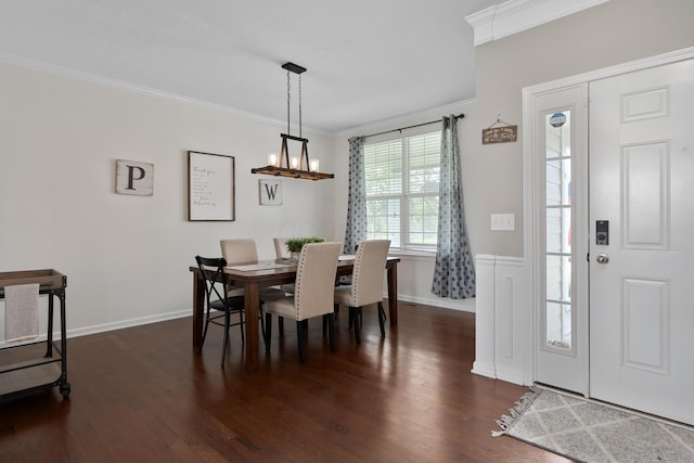 dining space featuring baseboards, ornamental molding, dark wood-style flooring, and a notable chandelier
