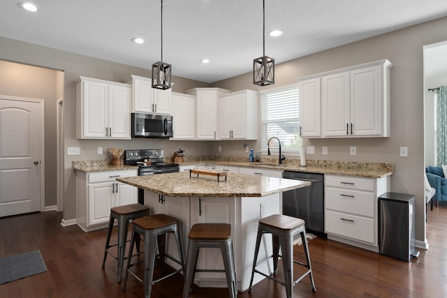 kitchen with a sink, appliances with stainless steel finishes, and white cabinetry